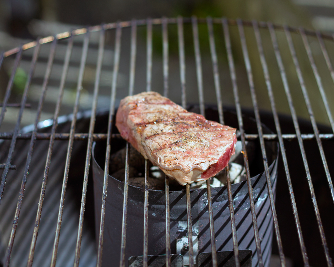 Searing eye fillet steak over hot coals