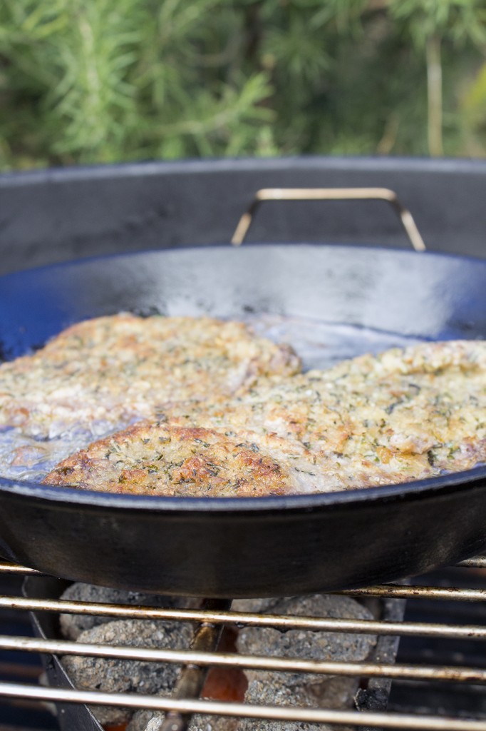 Fresh Herb-Crumbed Schnitzel Sizzling in a Cast Iron Pan